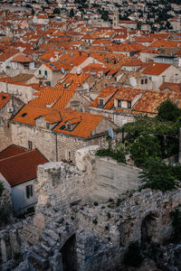 High angle view of abandoned historic building by houses in town