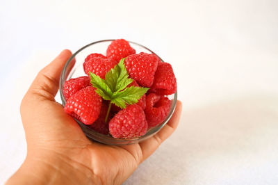 Close-up of hand holding strawberries