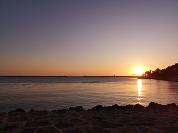 Scenic view of sea against clear sky during sunset