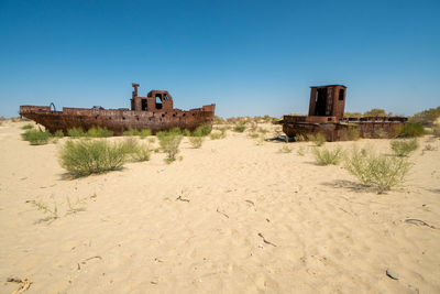 Built structure on land against clear blue sky