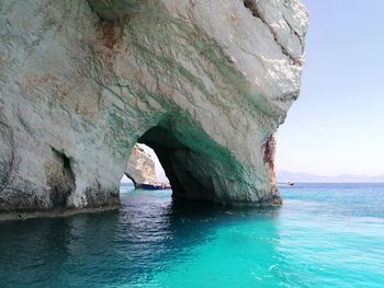 Scenic view of rock formation in sea against sky