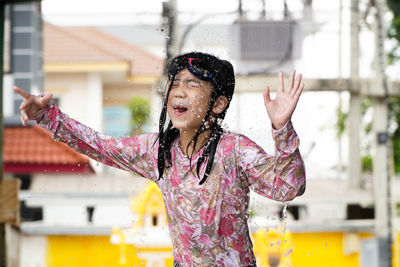 Full length of woman standing by water