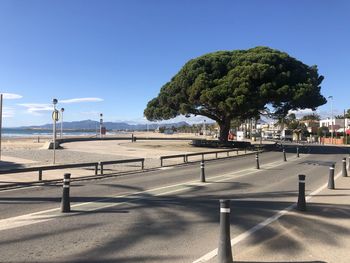 Street by sea against clear sky