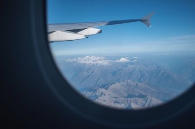 Aerial view of mountains seen through airplane window