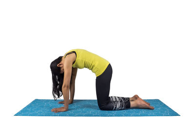 Full length of senior woman with arms raised against white background