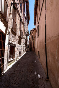 Narrow alley amidst buildings in town