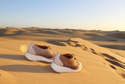 Sand dunes in desert against clear sky