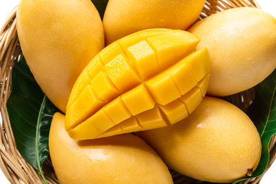 High angle view of mangoes in basket against white background