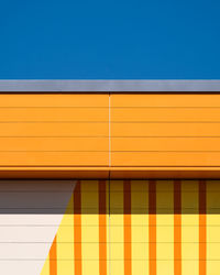 Low angle view of building against clear blue sky