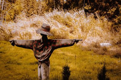 Rear view of person standing on field during autumn