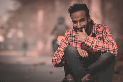 Portrait of young man sitting outdoors