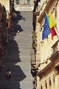 Group of people walking in city buildings