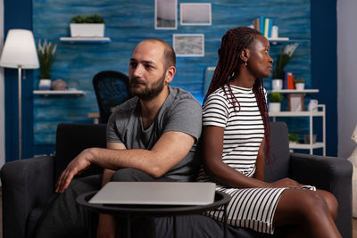 Young couple sitting on table