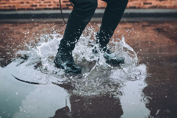 Low section of man standing in water