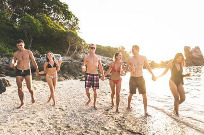 Friends enjoying at beach during summer