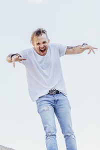 Portrait of smiling man standing against white background