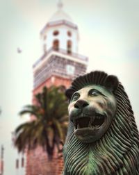 Low angle view of statue against building