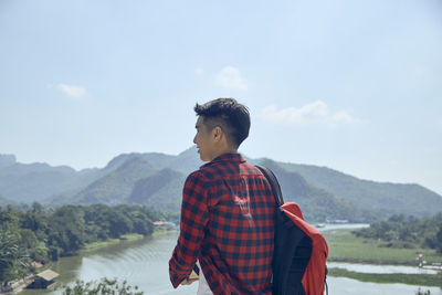 Man standing on mountain against sky