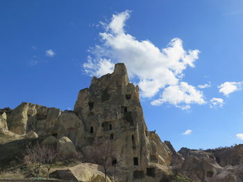 Low angle view of rock formations against sky