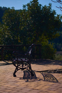 Empty chairs and table against trees in park