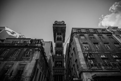 Low angle view of buildings in town against sky