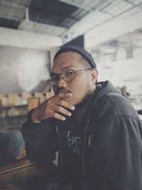 Portrait of young man sitting in cafe