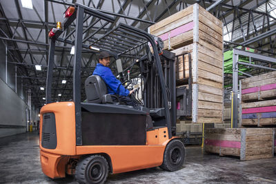 Man on forklift in factory hall