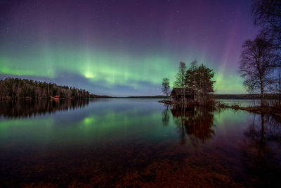 Summer cottage by the lake with northern lights