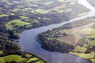 High angle view of river amidst agricultural field against sky