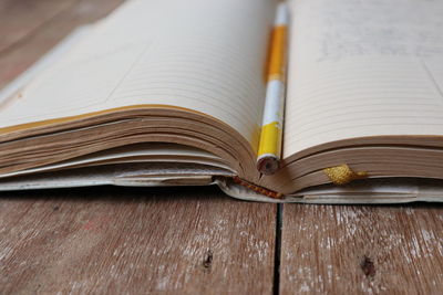 Close-up of pencil in book on table