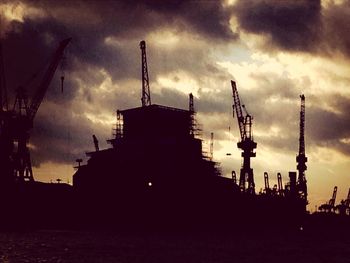 Crane against cloudy sky