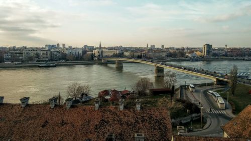 High angle view of river by buildings in city against sky