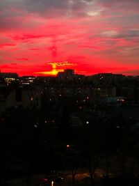 High angle view of illuminated buildings against sky at sunset