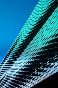 Low angle view of modern building against clear blue sky