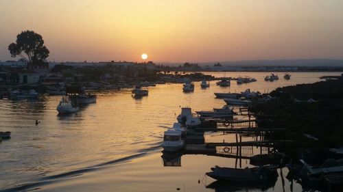 View of boats in sea at sunset