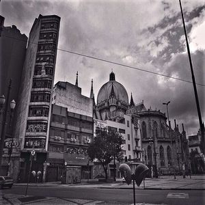 Buildings against cloudy sky