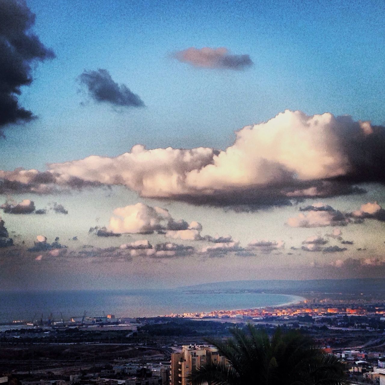 building exterior, sky, architecture, cityscape, city, built structure, cloud - sky, high angle view, sea, residential district, cloudy, residential building, crowded, residential structure, water, aerial view, scenics, cloud, sunset, nature