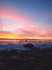 Scenic view of beach against sky during sunset