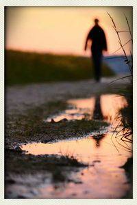 Woman standing at sunset