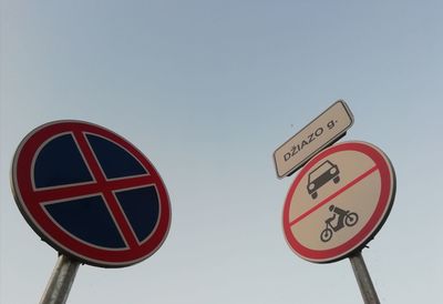 Low angle view of road sign against sky