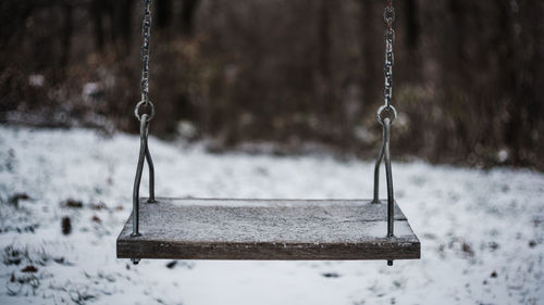 Close-up of empty swing in winter
