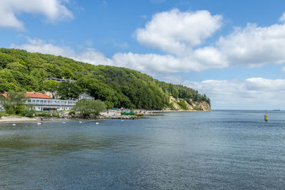 Scenic view of sea by building against sky