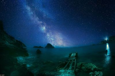 Scenic view of rocks against sky at night