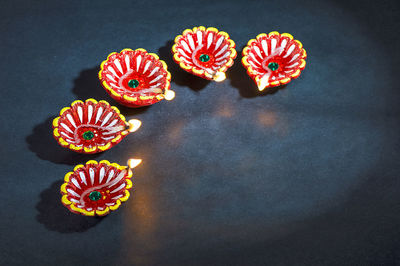 High angle view of multi colored candies against black background