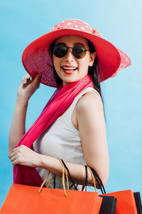 Portrait of smiling young woman wearing sunglasses