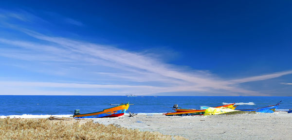 Scenic view of beach against blue sky