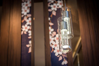 Close-up of illuminated glass hanging at home