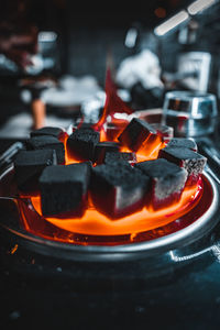 Close-up of burning candles on barbecue grill