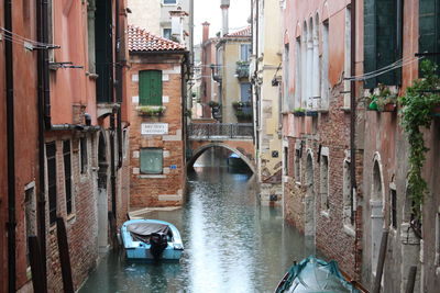 Bridge over canal amidst buildings in city