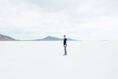 Full length of man standing on plain against sky